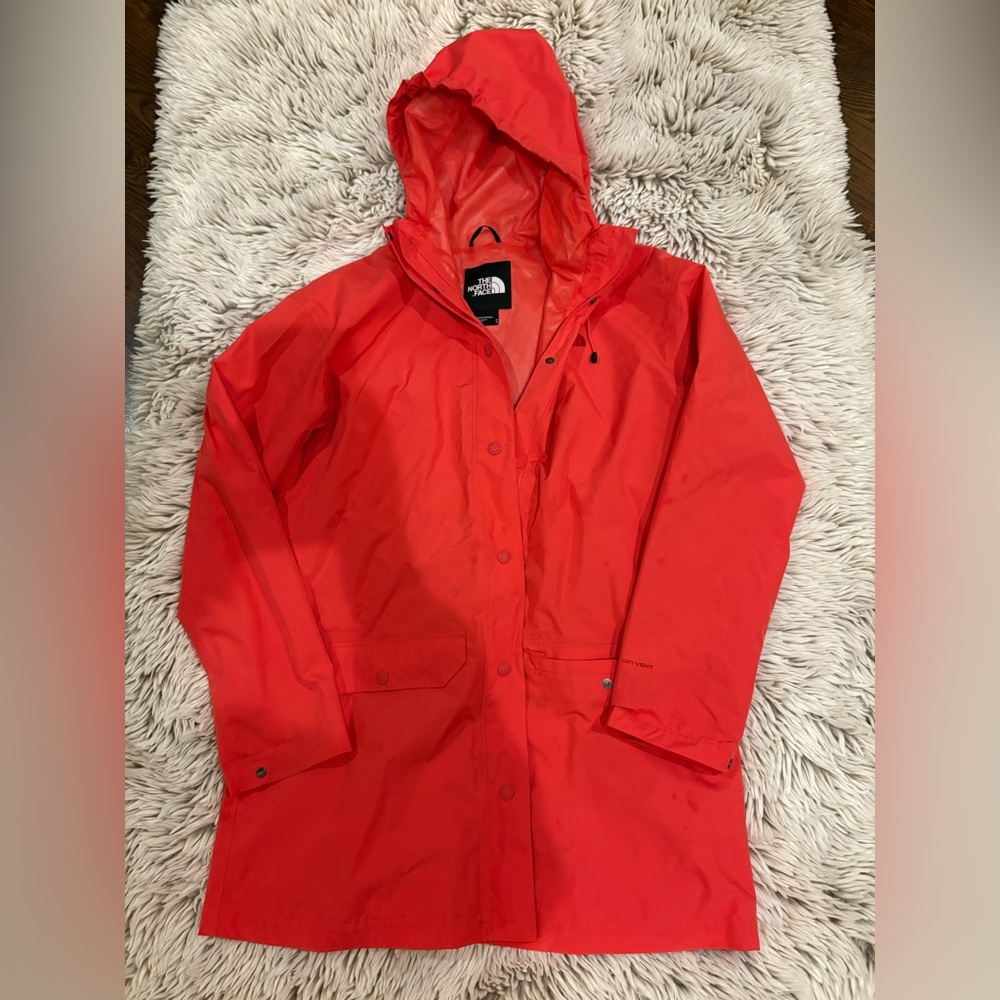 Orange Northface raincoat. Size medium. Mid thigh length. Dry vent